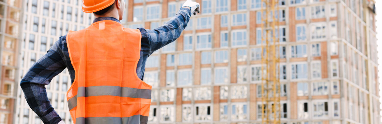 back-view-man-pointing-building back-view-man-pointing-building